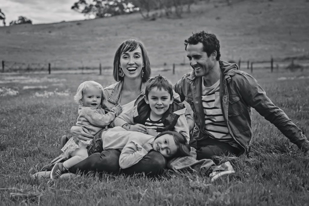 Photo of the Nield family, sitting together in a large field