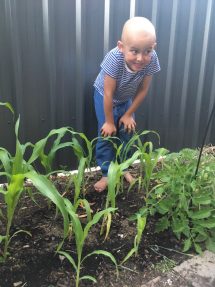 Rocco planting veggies outside the accommodation centre