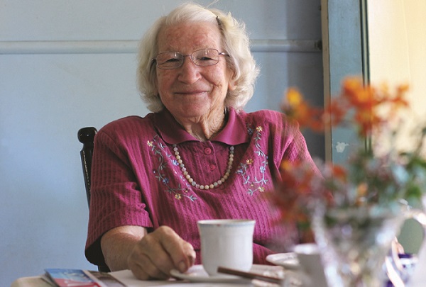Dot Crawford sitting at a table with a cup of tea