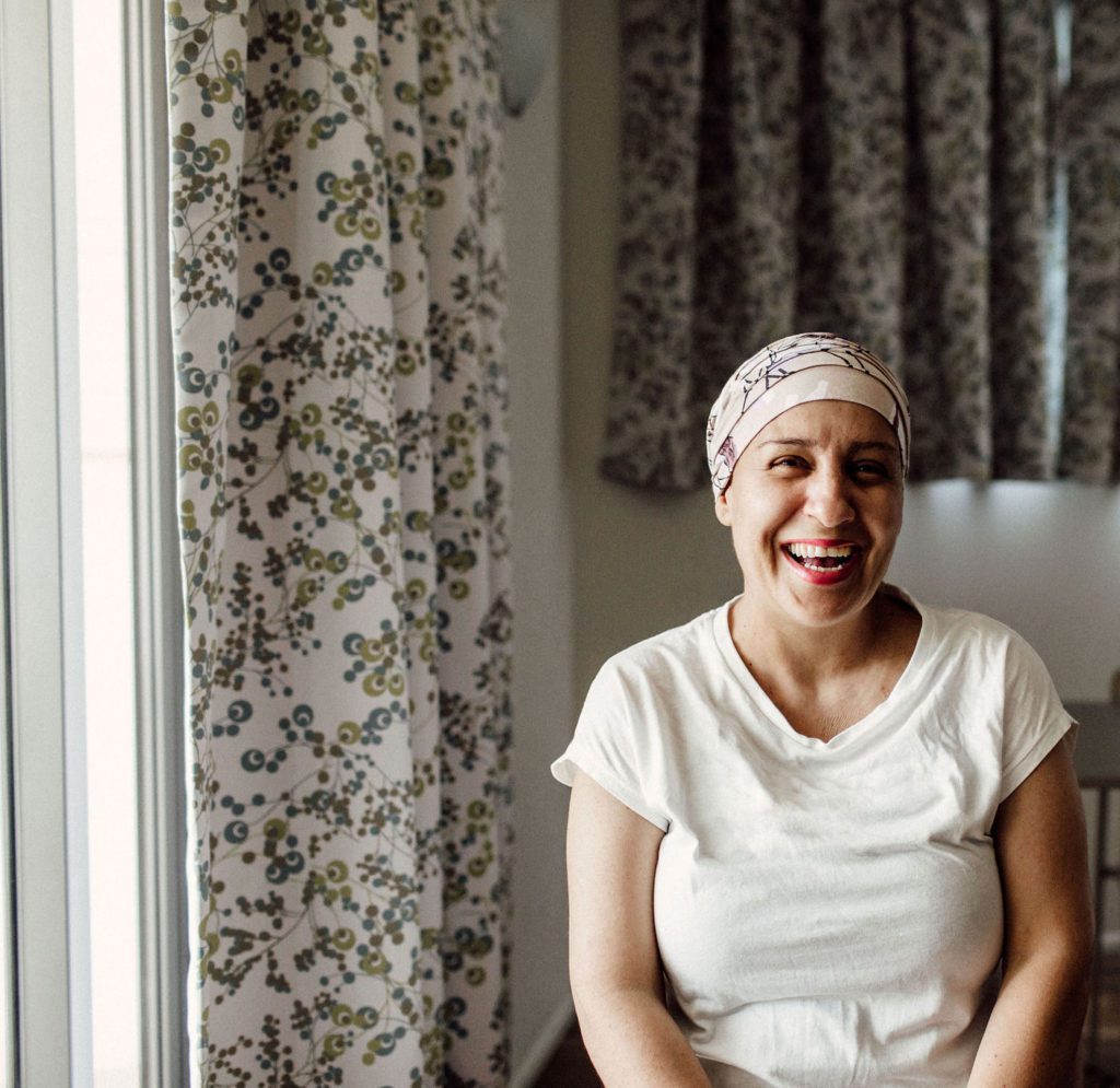 Woman in a headscarf smiling at the camera