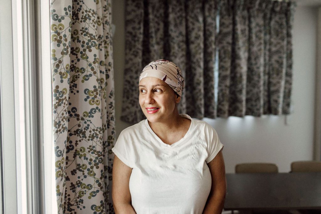 Woman in a headscarf looks out the window in a Leukaemia Foundation unit