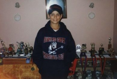 A young Matt with medals and trophies he and his two brothers had won, including the under 11s footy grand final for Diamond Creek in 2001. 