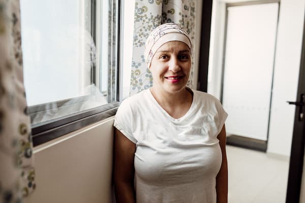Photograph of a woman in a headscarf, standing in a Leukaemia Foundation accommodation unit