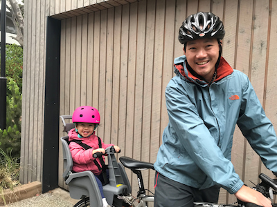 Dr Chun Fong bike riding with his daughter