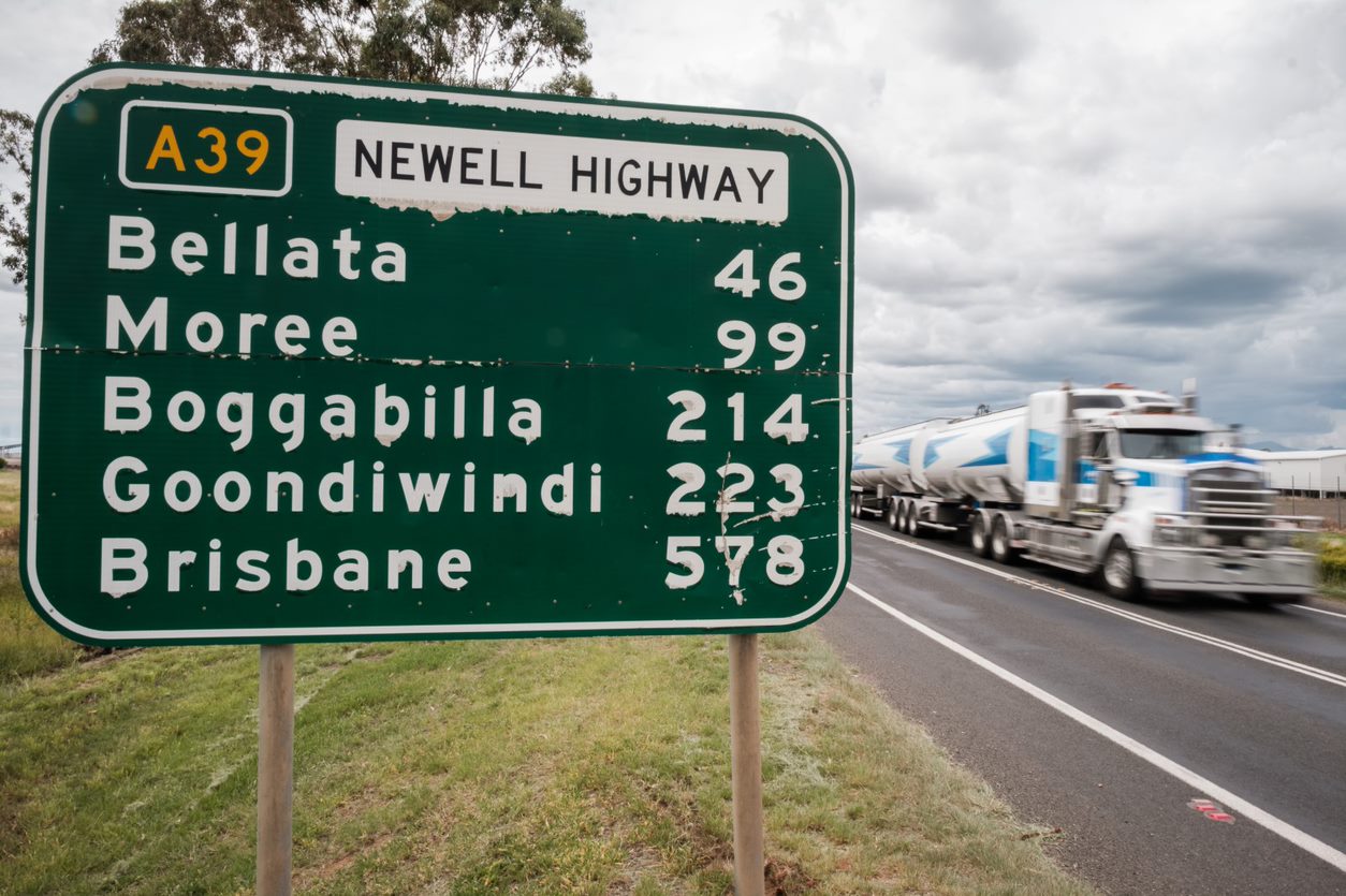 Photo of a highway road sign showing different towns in QLD