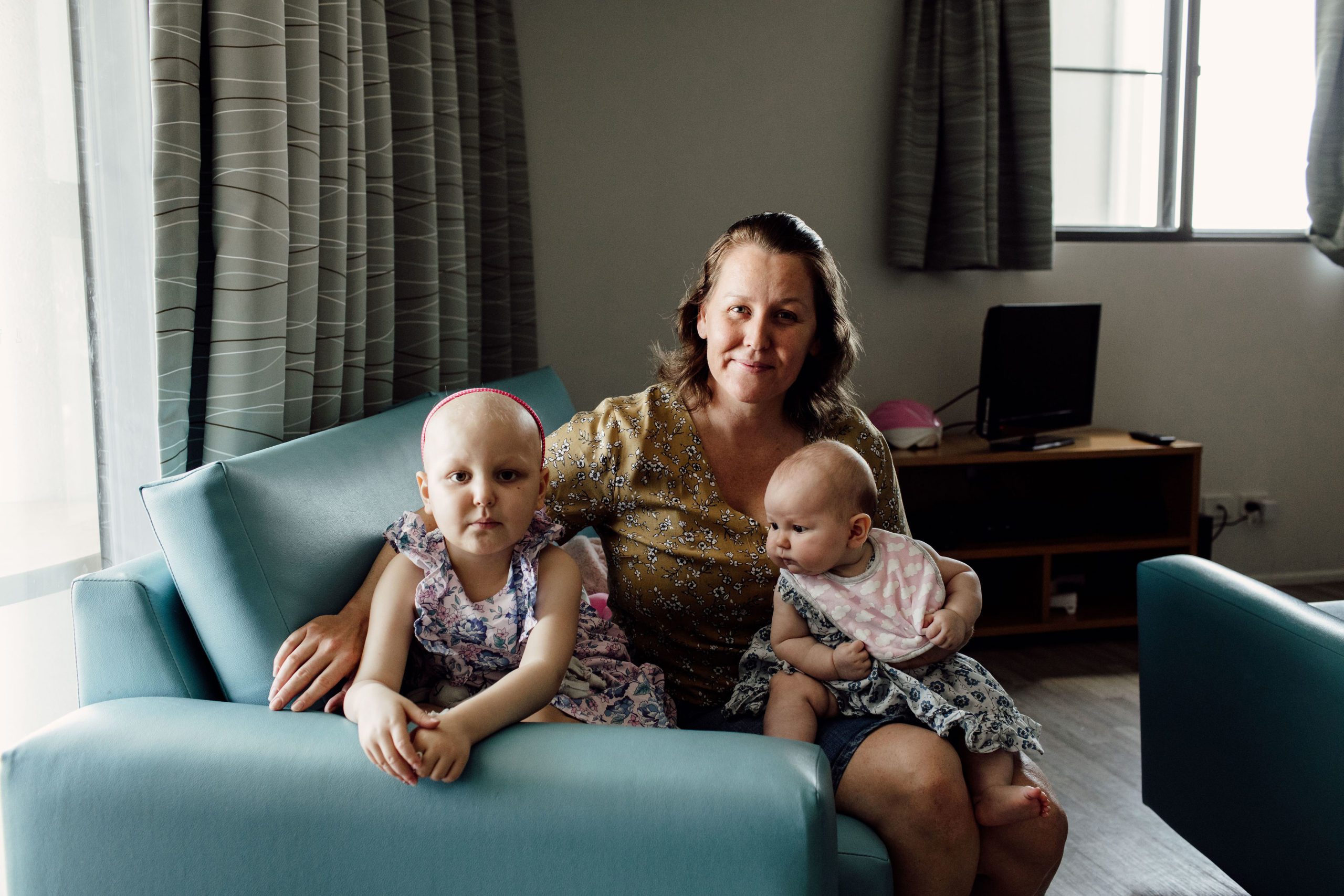 Arianna Baczynski, 4, and her family sitting in a Leukaemia Foundation accommodation unit