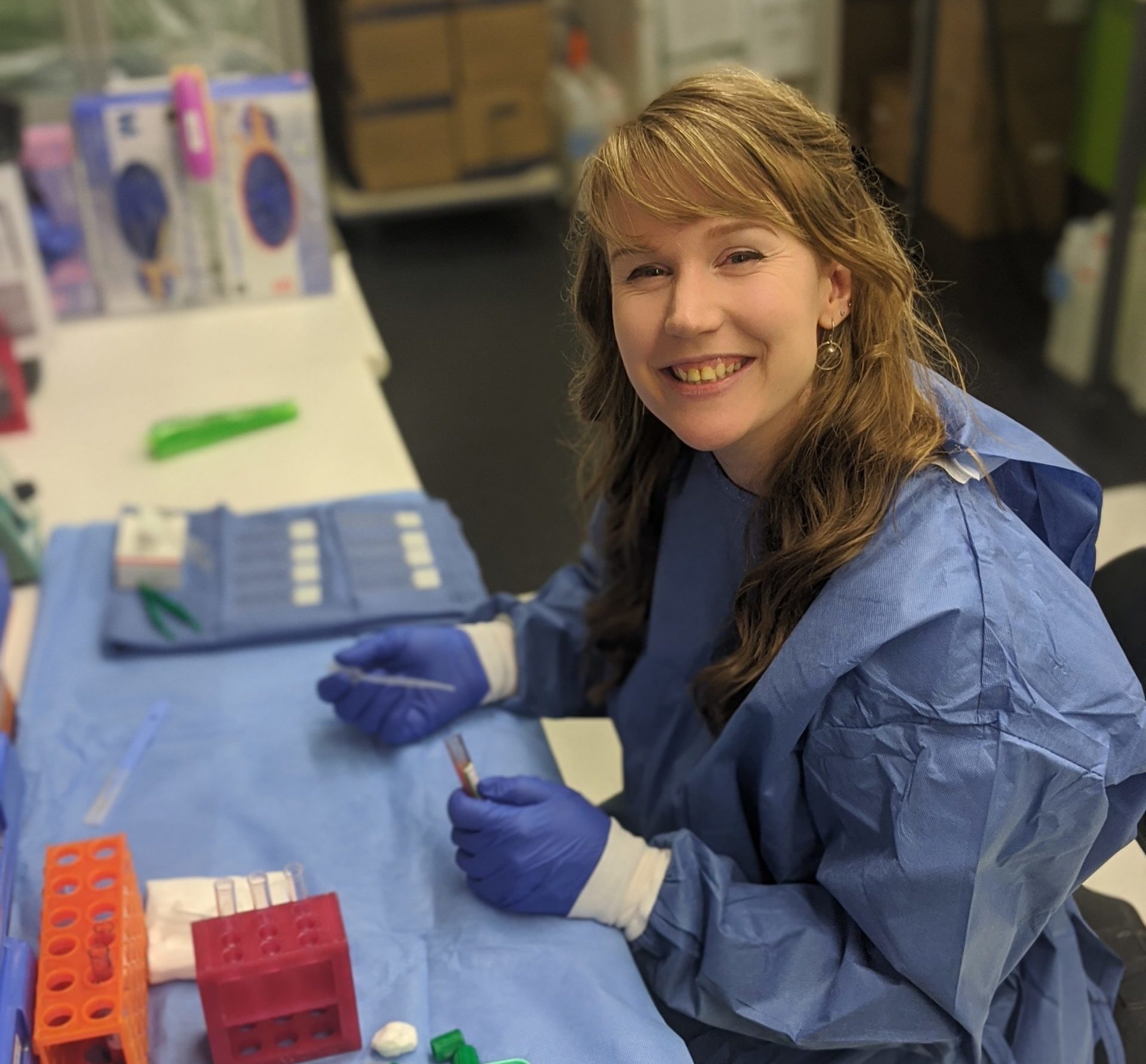 Dr Jessica Elliott in the lab, holding some test tubes