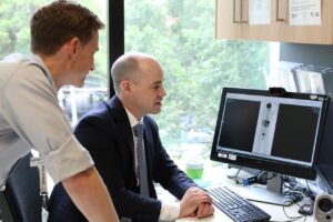 A/Prof. Michael Dickinson, right, checking a PET scan with Lymphoma Fellow, Dr Adrian Minson