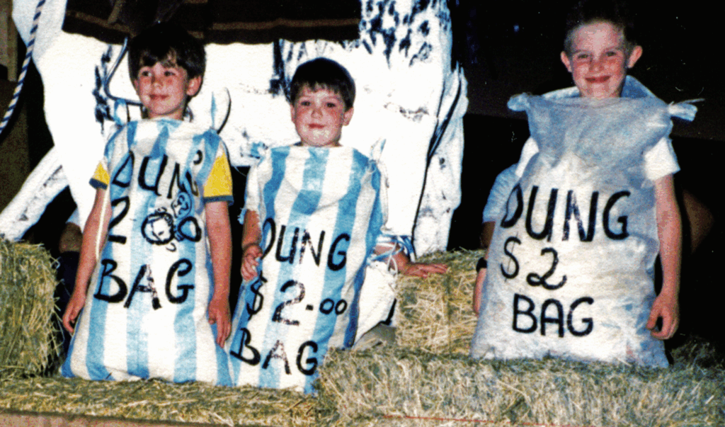 Young supporters of the Mount Isa Leukaemia Fund display $2 bags of dung collected during the infamous Dung Sundays, a favourite fundraising activity for Fund members.